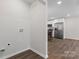 Utility connections and view of the kitchen in this laundry room at 2204 Hillcrest Ave, Albemarle, NC 28001