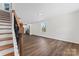 Bright living room featuring hardwood floors, stairs, and white walls at 2204 Hillcrest Ave, Albemarle, NC 28001