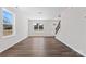 Living room with hardwood floors, two windows, and staircase to the upper level at 2204 Hillcrest Ave, Albemarle, NC 28001