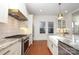 Modern kitchen with stainless steel appliances, granite countertops, and an open design for easy entertaining at 2304 Dilworth W Rd, Charlotte, NC 28203