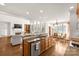 Open kitchen featuring an island with granite countertops that connects to a large Gathering room at 2333 Emma Grace Ln, Rock Hill, SC 29732