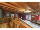 Inside the garage, there is a wooden staircase, red walls, and a pair of windows to bring in light at 26174 Treece Rd, Albemarle, NC 28001