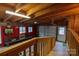 Inside the garage, featuring a roll-up door, red walls, and a wood framed ceiling at 26174 Treece Rd, Albemarle, NC 28001