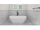 Elegant bathroom with freestanding tub, marble tile and modern fixtures at 2809 Glendale Rd, Charlotte, NC 28209