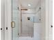 Sleek, glass enclosed shower featuring elegant tilework, bronze fixtures, and built-in bench at 2809 Glendale Rd, Charlotte, NC 28209