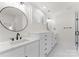 Modern bathroom featuring double sinks with marble countertops and cabinetry at 2809 Glendale Rd, Charlotte, NC 28209
