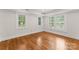 Bright bedroom with hardwood floors, shuttered windows, and fresh paint at 2809 Glendale Rd, Charlotte, NC 28209