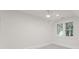 Bright bedroom featuring neutral carpeting, and a modern ceiling fan at 2809 Glendale Rd, Charlotte, NC 28209