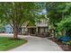Charming two-story home with lovely updated facade, decorative fence, and manicured landscaping along a private driveway at 2809 Glendale Rd, Charlotte, NC 28209