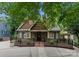 Charming two-story home with updated façade and landscaping, complemented by a stylish black fence and inviting front porch at 2809 Glendale Rd, Charlotte, NC 28209