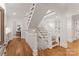 Open hallway featuring a staircase, hardwood floors, and views of the kitchen and living spaces at 2809 Glendale Rd, Charlotte, NC 28209