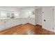 Basement kitchenette with white cabinets, hardwood floors, and a stylish design at 2809 Glendale Rd, Charlotte, NC 28209