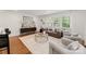 Bright living room featuring hardwood floors, stylish furniture, and natural light from shuttered windows at 2809 Glendale Rd, Charlotte, NC 28209