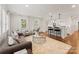 Elegant living room showcasing hardwood floors, white trim, and an open layout with access to the kitchen at 2809 Glendale Rd, Charlotte, NC 28209