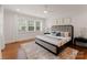 Bright main bedroom with hardwood floors, shuttered windows, and refined decor with neutral tones at 2809 Glendale Rd, Charlotte, NC 28209