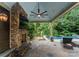 Outdoor living area with stone fireplace, ceiling fan and view of pool at 2809 Glendale Rd, Charlotte, NC 28209