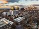A panoramic view of the cityscape shows modern buildings against a golden, cloudy sky at sunset at 287 Mcdonald Ave, Charlotte, NC 28203