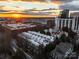 A picture of a cityscape with a mix of residential and commercial buildings is silhouetted at sunset at 287 Mcdonald Ave, Charlotte, NC 28203