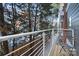 Wooden decked balcony with white railings overlooking the yard at 287 Mcdonald Ave, Charlotte, NC 28203