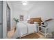 Cozy bedroom with a wood headboard, area rug and a side table with black lamp at 287 Mcdonald Ave, Charlotte, NC 28203