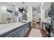 Open kitchen and living area with an island, modern fixtures, and stairs to the upper level at 287 Mcdonald Ave, Charlotte, NC 28203