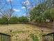 Large, fenced backyard with mature trees and well-maintained lawn at 331 E White St, Rock Hill, SC 29730