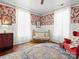 Bright Bedroom with large windows, decorative wallpaper, and a vintage crib at 331 E White St, Rock Hill, SC 29730