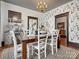 Inviting dining area with patterned wallpaper, dark trim, and a view into the kitchen at 331 E White St, Rock Hill, SC 29730