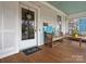 Charming front porch with painted wood, bench seating and a view to the front yard at 331 E White St, Rock Hill, SC 29730