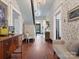 Hallway with hardwood floors, patterned wallpaper, chandelier, and elegant furnishings at 331 E White St, Rock Hill, SC 29730