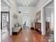 The hallway with hardwood floors is decorated with wallpaper, furniture, and a chandelier at 331 E White St, Rock Hill, SC 29730