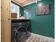 The laundry room boasts a modern washer and dryer, with whimsical decor and tiled floors at 331 E White St, Rock Hill, SC 29730