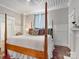 Bright and airy main bedroom with a four poster bed, panel moulding and hardwood floors at 331 E White St, Rock Hill, SC 29730