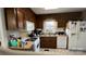Traditional kitchen with wood cabinets, white appliances, and a window above the sink at 3331 Tamworth Ln, Gastonia, NC 28052