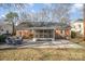 Large backyard with a brick home, patio with table set and a screened-in porch at 4001 Glenfall Ave, Charlotte, NC 28210