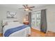Bright bedroom with a white bed, hardwood floors, and a large window at 4001 Glenfall Ave, Charlotte, NC 28210