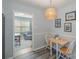 Cozy dining area with a light fixture, wood floors, and view to the living room at 4001 Glenfall Ave, Charlotte, NC 28210