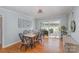 Bright dining room featuring hardwood floors, contemporary lighting, and access to the patio at 4001 Glenfall Ave, Charlotte, NC 28210