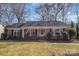 Charming single-story brick home with a cozy front porch and well-maintained landscaping at 4001 Glenfall Ave, Charlotte, NC 28210