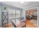 Comfortable home office with natural light, hardwood floors, and an open view to the living area at 4001 Glenfall Ave, Charlotte, NC 28210