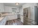 Bright kitchen featuring white cabinetry, stainless steel appliances, and durable gray countertops at 4001 Glenfall Ave, Charlotte, NC 28210