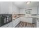 Well-lit kitchen features white cabinetry, stainless steel appliances, and efficient layout at 4001 Glenfall Ave, Charlotte, NC 28210