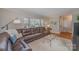 Inviting living room with a large, comfortable brown leather sofa and plenty of natural light at 4001 Glenfall Ave, Charlotte, NC 28210