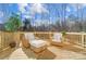 Outdoor deck area featuring patio furniture overlooking a wooded backyard at 4114 Thames River Pl, Harrisburg, NC 28075