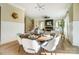 Elegant dining area with a round table, stylish chairs, and a view of the living room at 4114 Thames River Pl, Harrisburg, NC 28075