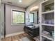 Modern bathroom with floating vanity, large window, and open shelving at 4129 Carnoustie Ln, Charlotte, NC 28210