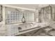 Large bathroom with soaking tub, glass shower, and marble flooring at 4129 Carnoustie Ln, Charlotte, NC 28210