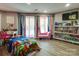 Bright bedroom with a Sonic themed bedspread, a desk and large windows at 4129 Carnoustie Ln, Charlotte, NC 28210