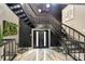 Grand entryway with a sweeping staircase and marble flooring at 4129 Carnoustie Ln, Charlotte, NC 28210