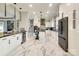 Modern kitchen featuring white cabinets, marble floors, and stainless steel appliances at 4129 Carnoustie Ln, Charlotte, NC 28210